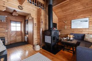 a living room with a fireplace in a log cabin at Ski-in/Ski-out | Sauna | Pets allowed | Terrace in Lofsdalen +7 photos