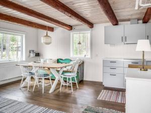 a kitchen with a table and chairs in a room at Fishing area | Wi-Fi 100/100 | Terrace | Washing machine in Lofsdalen