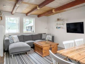a living room with a couch and a table at Fishing area | Wi-Fi 100/100 | Terrace | Washing machine in Lofsdalen