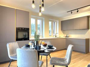 a kitchen and dining room with a table and chairs at Cozy Tartu Apple Garden Superior in Tartu