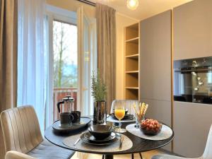 a dining room table with two chairs and a table with drinks at Cozy Tartu Apple Garden Superior in Tartu +15 photos