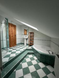 a large bathroom with a tub and a sink at Holiday house Morávkovi in Horní Branná