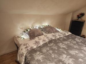 a bedroom with a bed with christmas lights on it at Cosy Duplex proche Paris in Épinay-sur-Seine