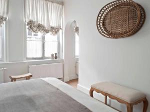 a bedroom with a bed and a chair and windows at Guesthouse Groeninghe in the centre of Bruges in Bruges +44 photos