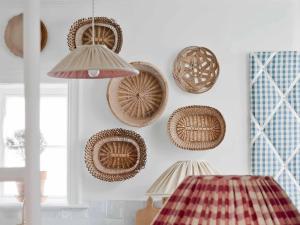 a bunch of baskets hanging on a wall at Guesthouse Groeninghe in the centre of Bruges in Bruges