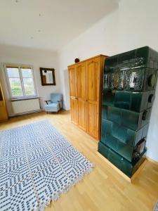 a living room with a rug on a wooden floor at Appartement Cseho in Murau +1 photo