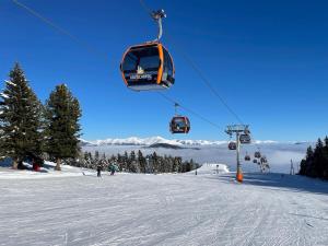 a ski lift going up a snow covered ski slope at Appartement Cseho in Murau