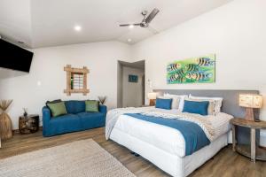 a bedroom with a bed and a blue couch at Cape Byron Suite 5 Private Suite with Ensuite in Byron Bay +29 photos