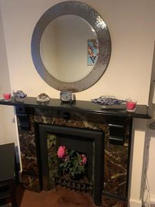 a fireplace with a mirror on top of it at Apartment, Stylish 2 bed Riverside House, 2 Kingsize beds, Free Parking in Southampton +31 photos