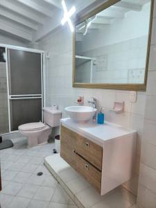 Casa turística contemporánea في بوكارامانغا: حمام مع حوض ومرحاض ومرآة