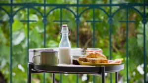 a table with a plate of food and a bottle of milk at O Ateneu in Ponta Delgada