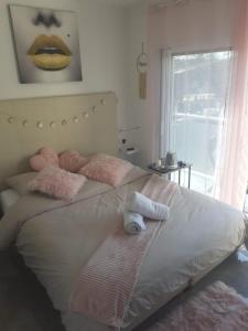 a bedroom with a bed with stuffed animals on it at Love Room Charme in Tremblay En France +4 photos