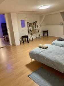 a room with two beds and a wooden floor at Charmante maison de 140m2 au bord de la rivière au coeur de Wissembourg in Wissembourg
