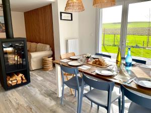a dining room with a table and chairs and a fireplace at Villa 800 in Wissant