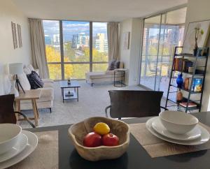 a living room with a bowl of fruit on a table at Cherry Creek Condo in Denver