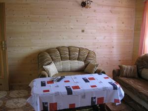a living room with a couch and a table at Całoroczne Domki Zacisze Hnatowego Berda w Wetlinie in Wetlina
