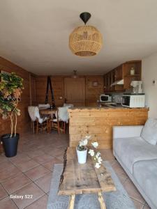 a living room with a couch and a table at Chalet de Manigod in Manigod +21 photos