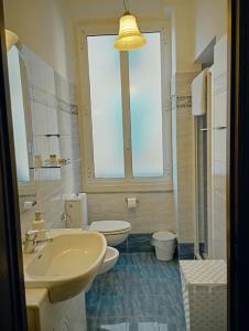 a bathroom with a sink and a toilet and a window at Small Luxury House in La Spezia +37 photos