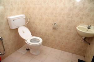 a bathroom with a toilet and a sink at Crystal Palace Odayam in Varkala +23 photos