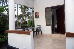 a balcony with a table and chairs in a house at Crystal Palace Odayam in Varkala