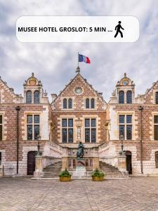 a building with a flag on top of it at Studio GOOD VIBES - Wifi - Cosy - Hyper-centre in Orléans