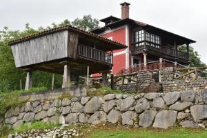 a house on top of a stone wall at Casa Escuela de Torín - La Casona de Torin in Torín
