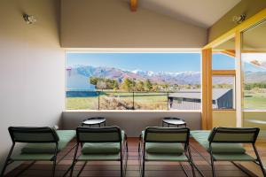 a waiting room with chairs and a large window at Passage LODGE Hakuba in Hakuba +25 photos