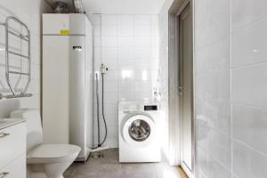 a bathroom with a washing machine and a toilet at Bastuvallen - Ramundberget in Bruksvallarna +69 photos