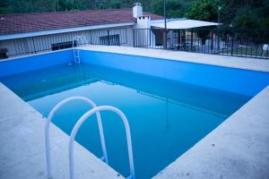 einem Pool mit blauem Wasser vor einem Gebäude in der Unterkunft Silencio Dorado in Villa Serranita