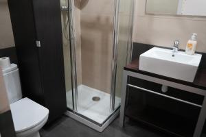 a bathroom with a shower and a toilet and a sink at Tgna Lluria 11 in Tarragona +21 photos