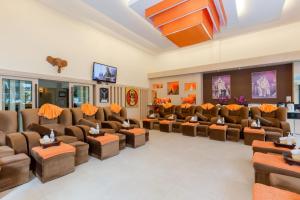 a large waiting room with couches and tables at The Golden Ville Boutique Hotel and Spa in Pattaya Central