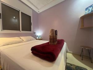 a bedroom with a bed with a red blanket at Sweet Taghazout Studios in Taghazout