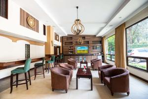 uma sala de espera num hotel com cadeiras e mesas em Heri Heights Hotel Apartments, SureStay Collection by Best Western em Nairobi