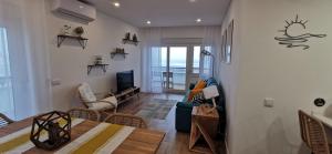 a living room with a couch and a table at Apartamento Varanda do Sol in Monte Gordo