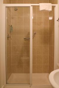 a shower with a glass door in a bathroom at Doolin Village Lodges in Doolin +22 photos