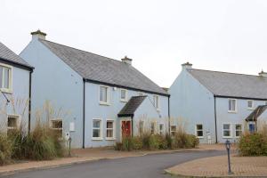a row of white houses on a street at Doolin Village Lodges in Doolin