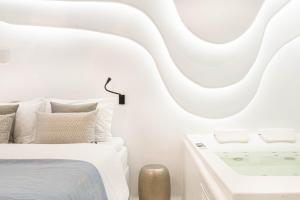 A bed or beds in a room at AMMOS at AmazeU Suites Naxos