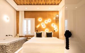 A bed or beds in a room at AMMOS at AmazeU Suites Naxos