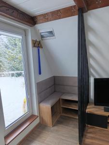 a tiny house with a window and a tv at Zawojskie Spanie in Zawoja