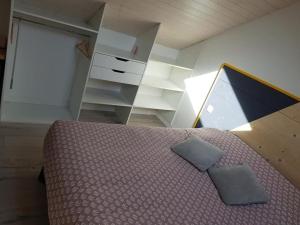 a bedroom with a bed and a dresser at Maison de Vacances LUCYANN in Avrillé