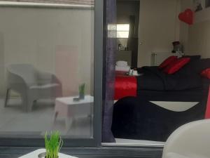 a bedroom with a bed with red pillows on it at Love Room Sensuelle in Tremblay En France