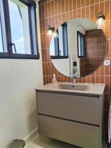 a bathroom with a sink and a mirror at Kerastrobel in Crozon +37 photos