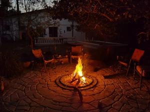a fire pit in the middle of a patio at night at Arijaana Guesthouse in Gunjur +9 photos