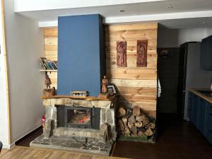 a fireplace in a kitchen with a blue wall at Połoninka in Ustrzyki Górne