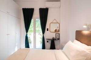 a bedroom with a bed and a window at 1BR Stylish Apt 20 Minutes from Acropolis in Athens
