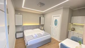 a bedroom with a bed with two towels on it at Guest house Luli Strumi in Berat