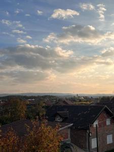 a view of roofs of houses under a cloudy sky at Home sweet home in Petrovaradin