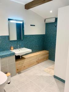 a bathroom with a sink and a toilet at Le Beuty in La Bresse +3 photos