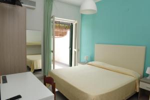 Postel nebo postele na pokoji v ubytování Hotel Costa d'Oro