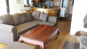 a living room with a couch and a coffee table at Seehaus Weiss in Rothenthurn